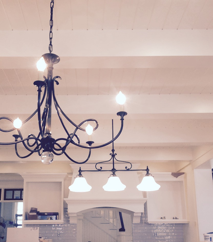 Painted interior with chandelier and plank ceiling